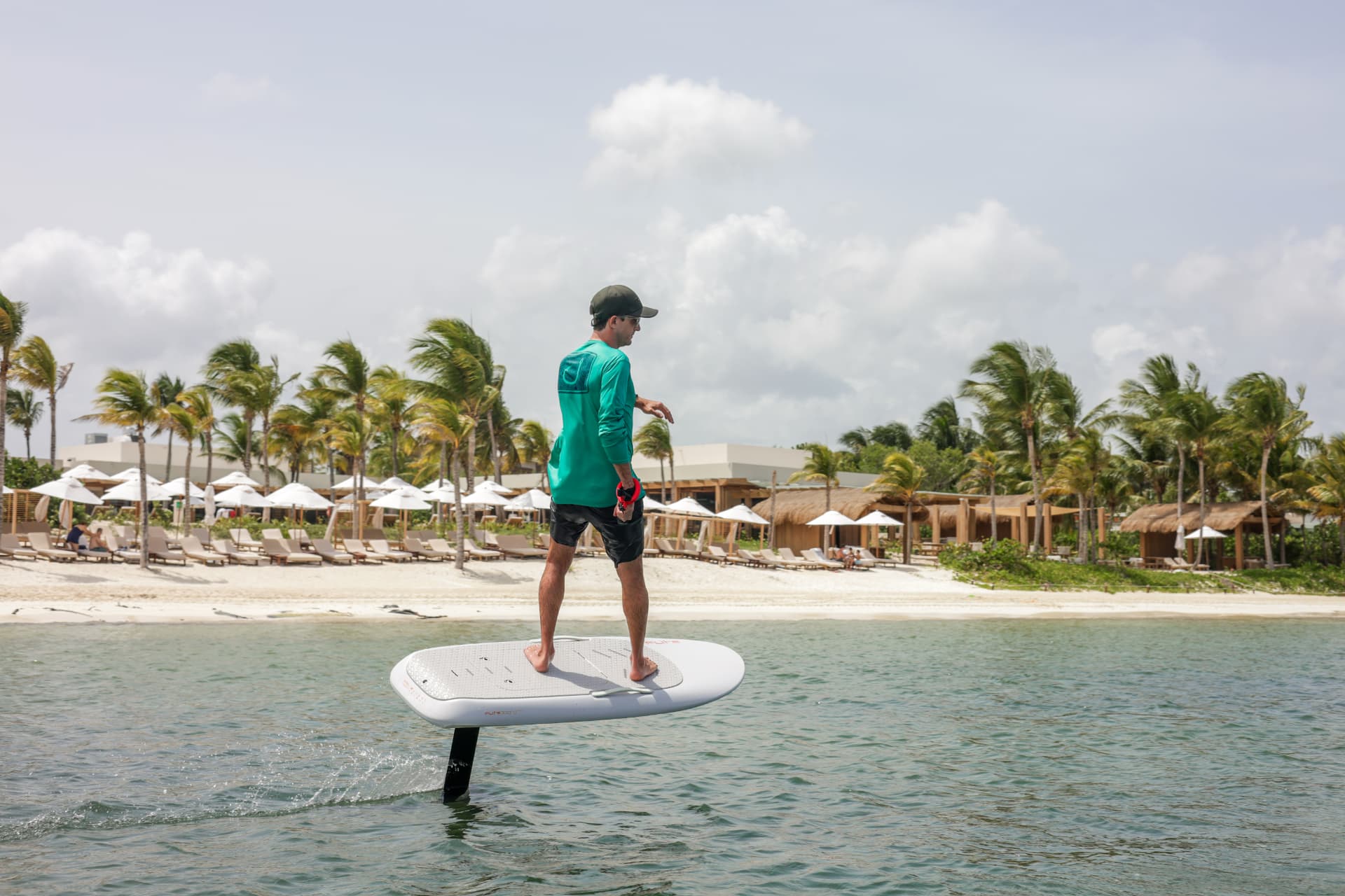 Fliteboard rider in flight in front of the Mayakoba beach club